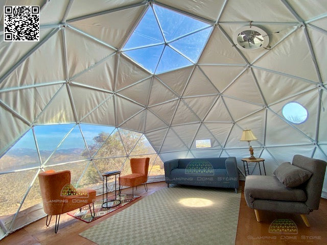 Spacious interior of a 16.4-foot (5-meter) geodesic dome tent, sold by Glamping Dome Store, located in Westminster, California, USA. The dome features modern furniture, including a blue sofa, orange chairs, and a coffee table. A transparent PVC window provides panoramic views of the surrounding landscape, making it ideal for luxury glamping, eco-living, or unique event spaces.
