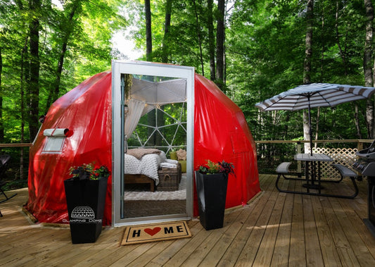 red geodesic dome on deck in the forest