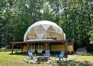 white geodesic dome tent on a raised platform