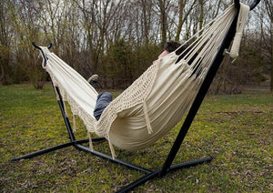 man using a free-standing hammock
